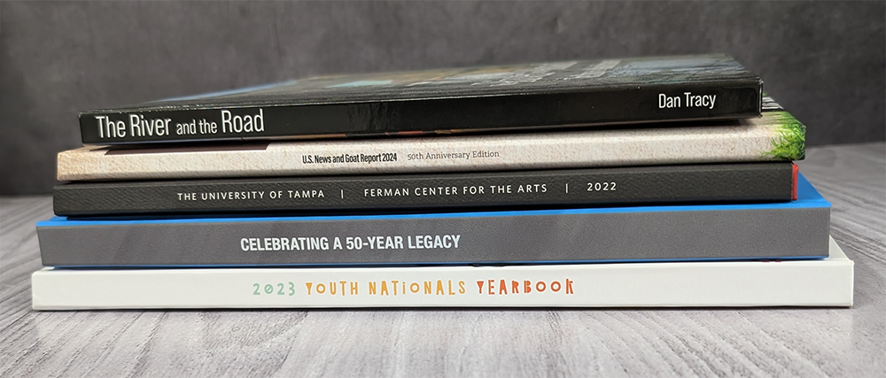 Stack showing the spines of five casebound hardcover books