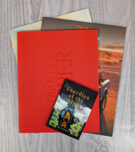Flat lay overlapping pile of Perfect Bound books in various sizes and colors
