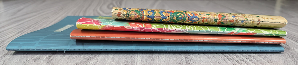 Spines of four Singer sewn books in various colors and sizes