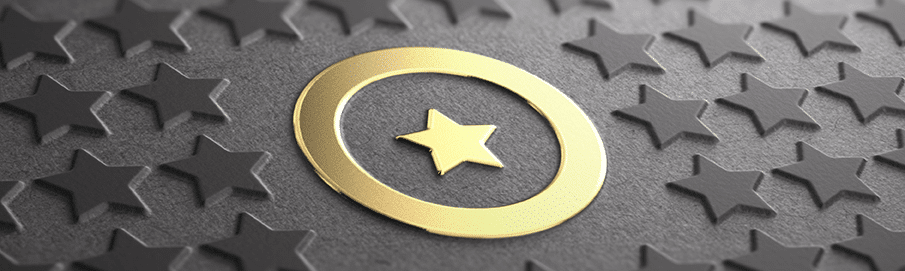 Black paper embossed with stars with a gold-foiled star circled in the middle